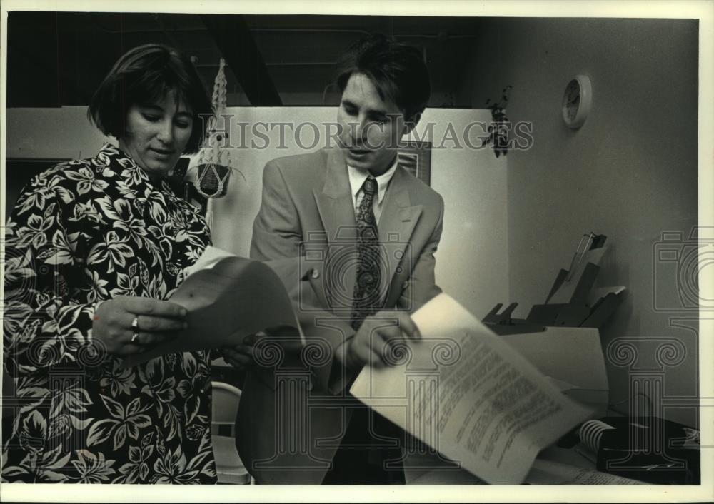 1993 Press Photo Catherine Deschamps Potter and Dany Olier look over material. - Historic Images