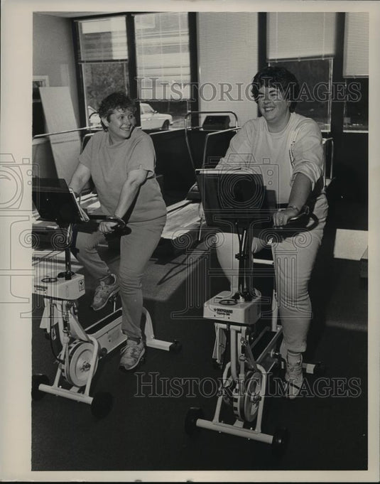 Press Photo Joyce Donohue, Anna Nash exercising on stationery bikes, Alabama - Historic Images