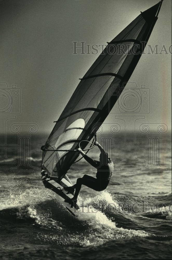 1990 Press Photo Jonathan Hauschka bounds the waves of Lake Michigan - Historic Images