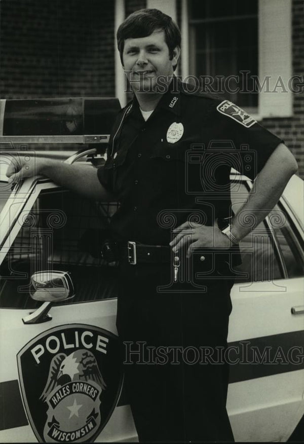 Author and Hales Corners police officer, Wayne Romels smiles, 1980
