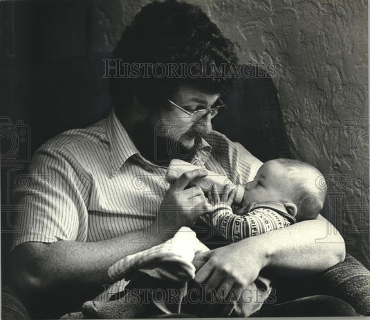 1980 Press Photo Warm bottle of milk brings Carl & Christopher Schwartz together - Historic Images