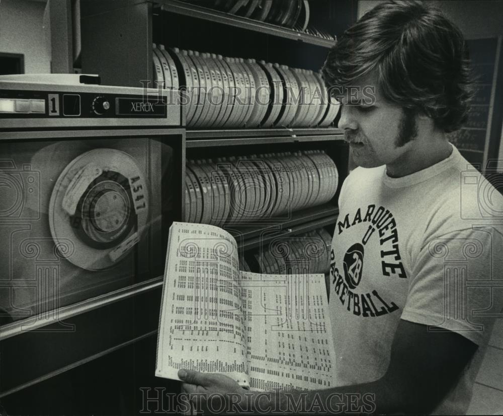 Greg Stack, in front of computer, looks at game printout, 1976 vintage ...