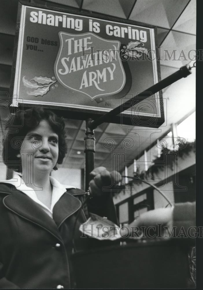 1979 Press Photo Person donates to Salvation Army bucket in Birmingham, Alabama - Historic Images