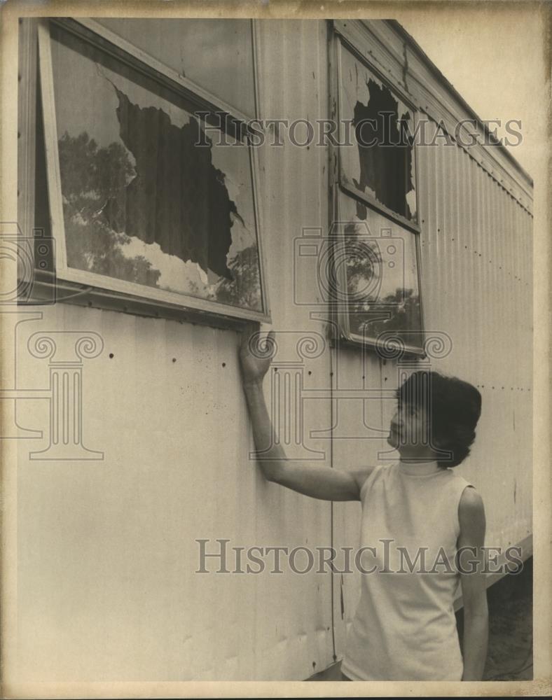 Press Photo Woman showcases broken windows at home - abna25028 - Historic Images