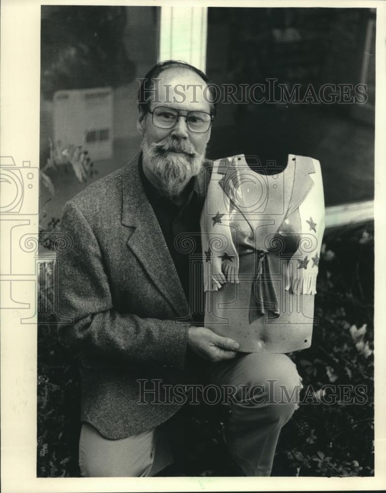 1987 Press Photo Richard C. Schneider held a breastplate featured in his show. - Historic Images