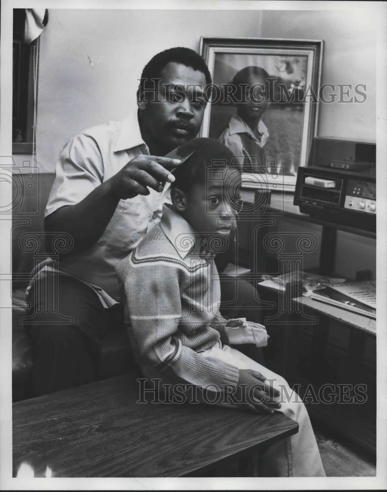 1977 Press Photo Timothy Howard combs young son&#39;s hair in Jefferson County - Historic Images
