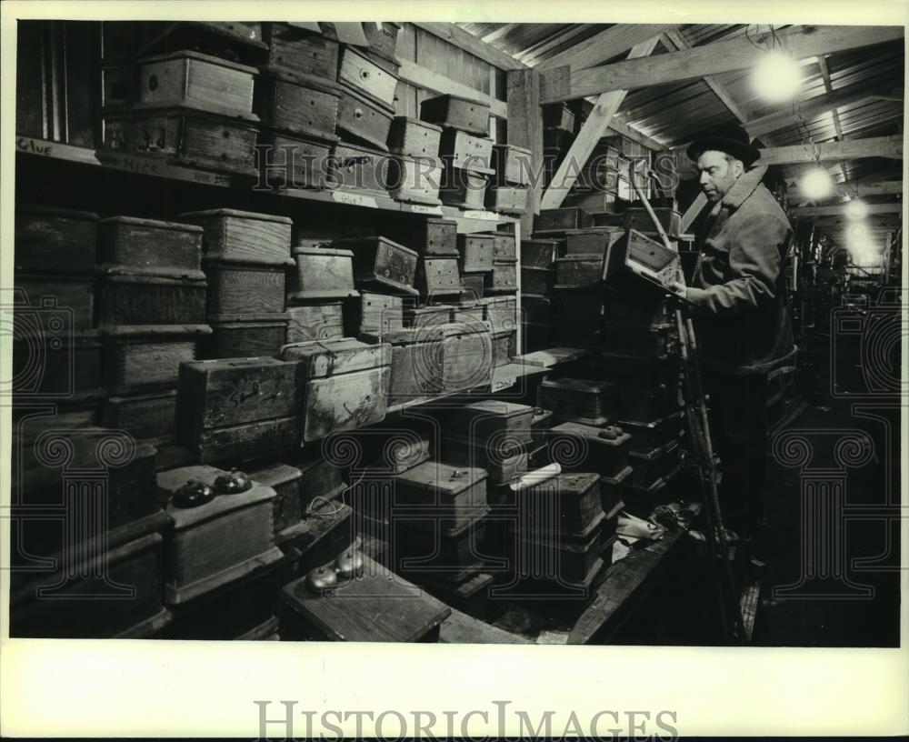 1983 Press Photo Ron Knappen Looks Over Some Wooden Phones - mjc07196 - Historic Images