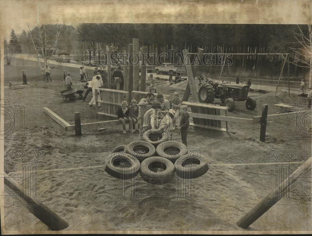 1984 Press Photo Children watch workers finish building a playground - mjc09061 - Historic Images