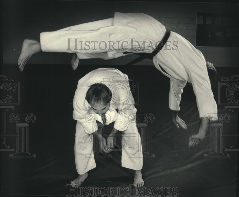 1986 Press Photo Gregg Rolloff leaps over brother Chris at Jujitsu practice - Historic Images