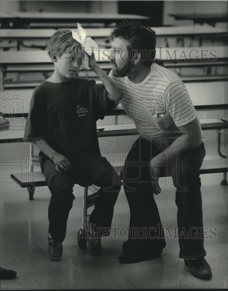 1984 Press Photo Dennis Faretta, comforts Jerry Zipfel after injury, Wisconsin - Historic Images