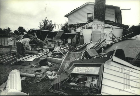1983 Press Photo Clarence Koehler sifts through storm-damaged home in Lisbon, WI - Historic Images