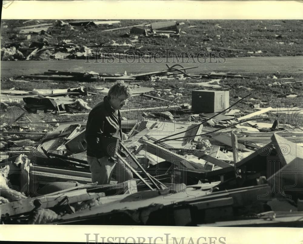 1985 Press Photo Donald Strode, Waukesha firefighter, surveys damage after storm - Historic Images