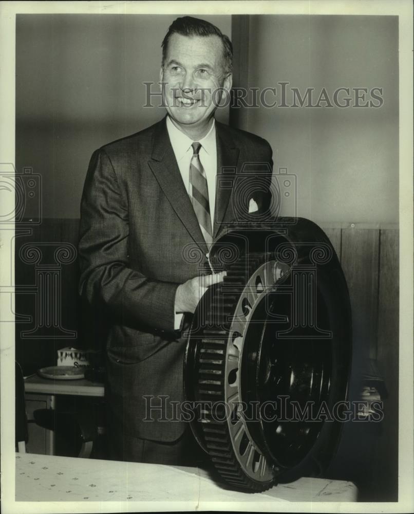 Press Photo Man showing new blowout protection within tire called PosiTrac. - Historic Images