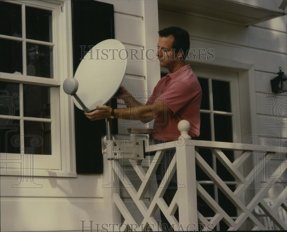 1994 Press Photo Man next to small broadcast satellite dish - mjc12419 - Historic Images
