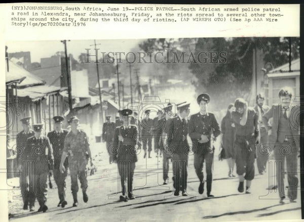 South African police patrol a road in Alexandra during riots, 1976 ...