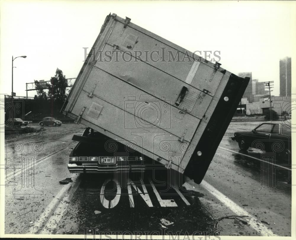 1983 Press Photo Semi truck on top of car after storm Los Angeles - mjc05196 - Historic Images