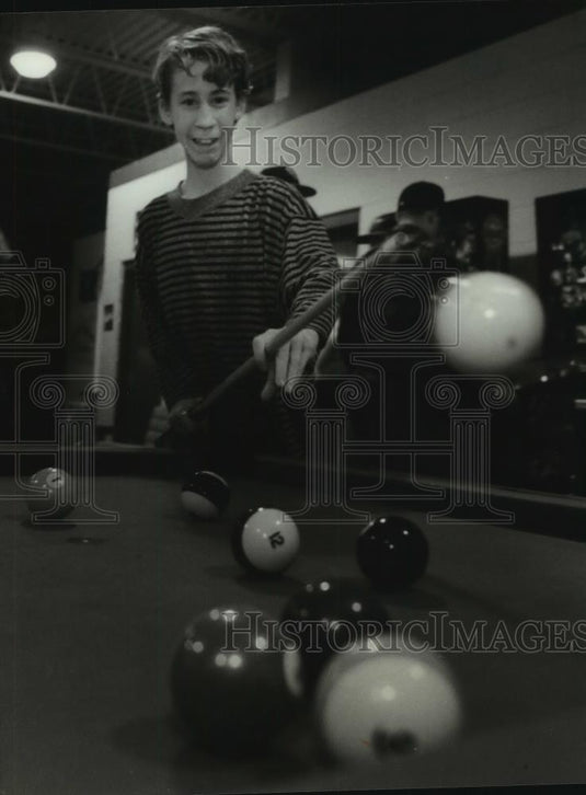 1994 Press Photo Brian Hickey, 15, knocks the cue ball into the air playing pool - Historic Images