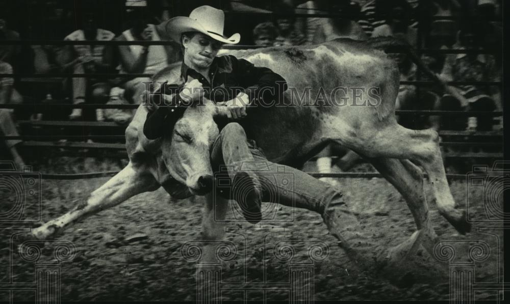 1984 Press Photo Cowboy Wrestles Steer in 2nd Annual World Championship Rodeo - Historic Images