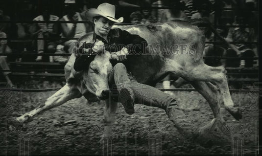 1984 Press Photo Cowboy Wrestles Steer in 2nd Annual World Championship Rodeo - Historic Images