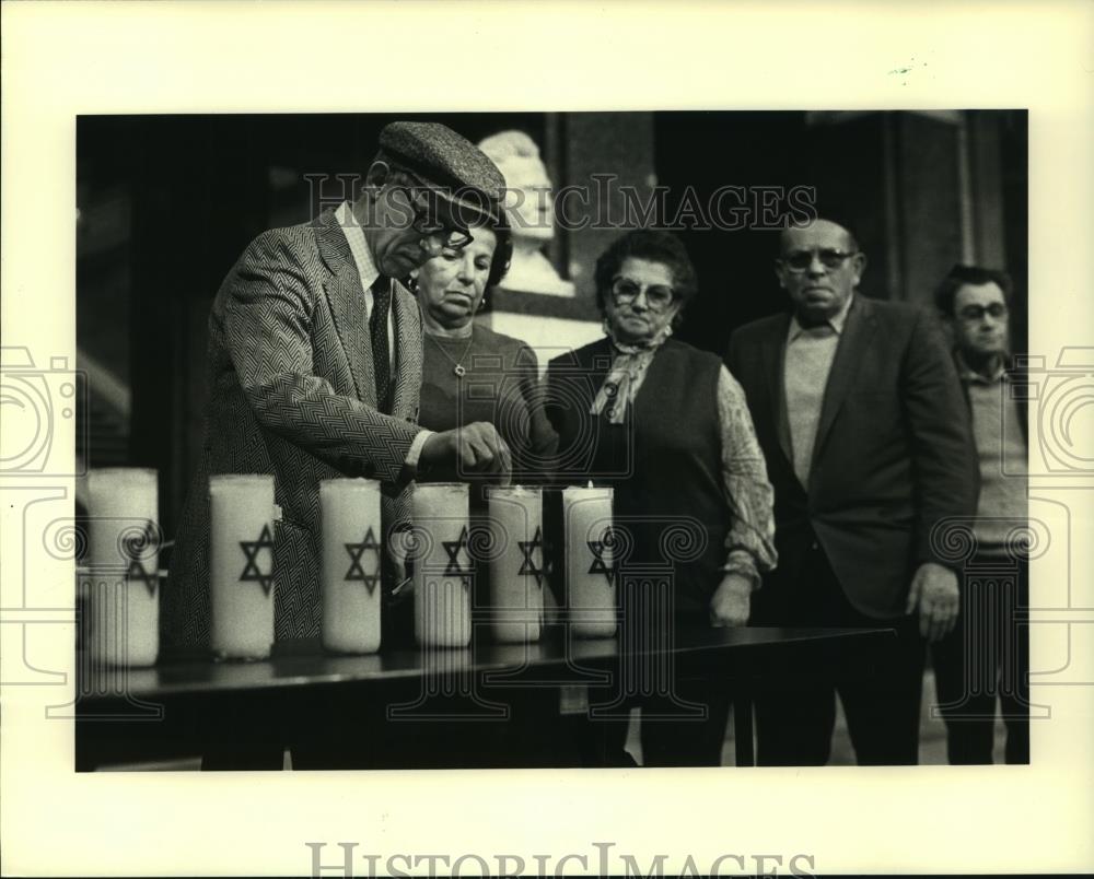 1984 Press Photo Holocaust survivors light candle at memorial service, Wisconsin - Historic Images