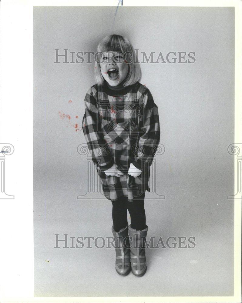 1984 Press Photo Laughing Child in Black and Red Dress - RRV56791 - Historic Images