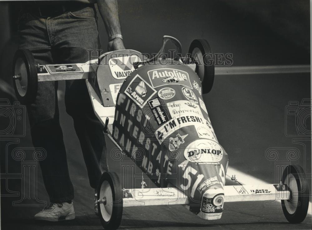 1988 Press Photo Official Picks Up Soap Box Derby Car After The Race - mjc23989 - Historic Images