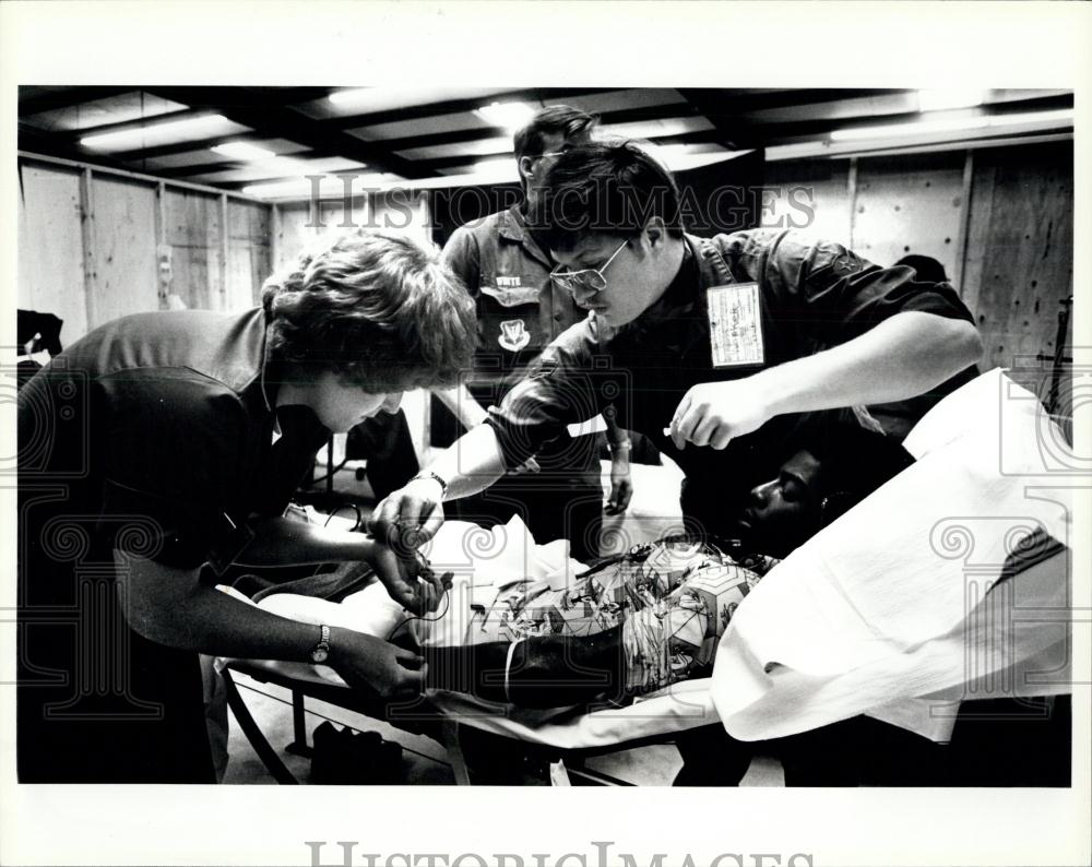 Press Photo Air Force medical personal work on Cuban refugee - Historic Images