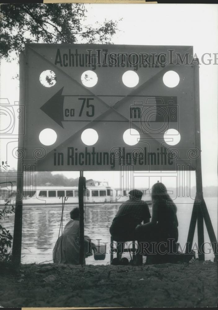 Press Photo Border sign in Berlin and a family fishing - Historic Images