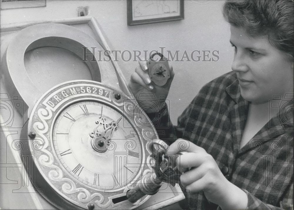 1965 Press Photo Woman Operates Giant Lock While Holding Smaller One Germany - Historic Images