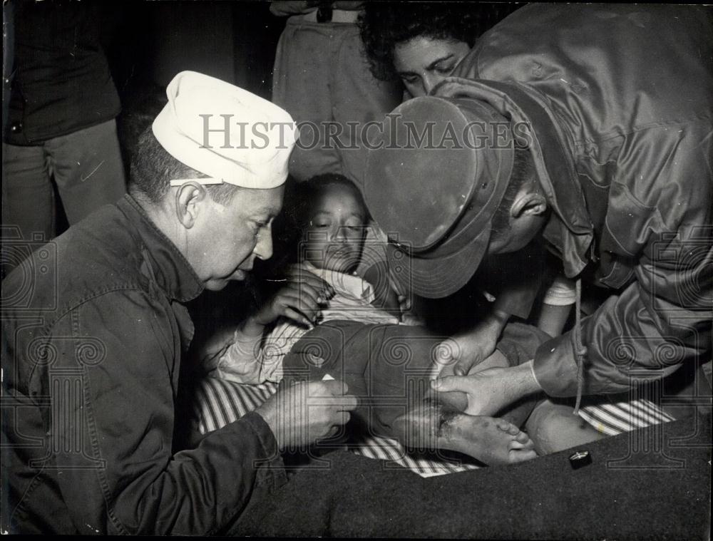 Press Photo Native Boy Suffering From Leg Injuries Being Given First Aid - Historic Images