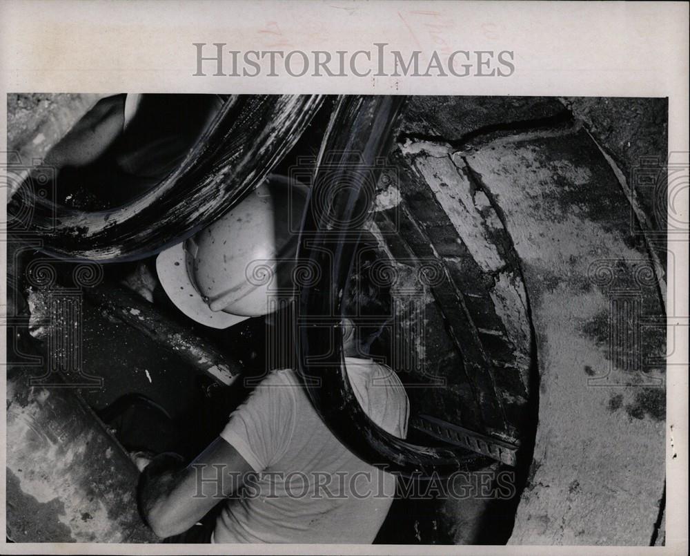 1970 Press Photo Workers repair water logged phone - Historic Images