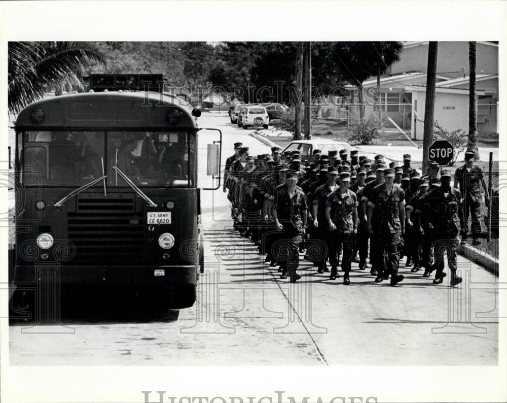Press Photo marines march past a bus full of newly arrived Cuban refugees - Historic Images