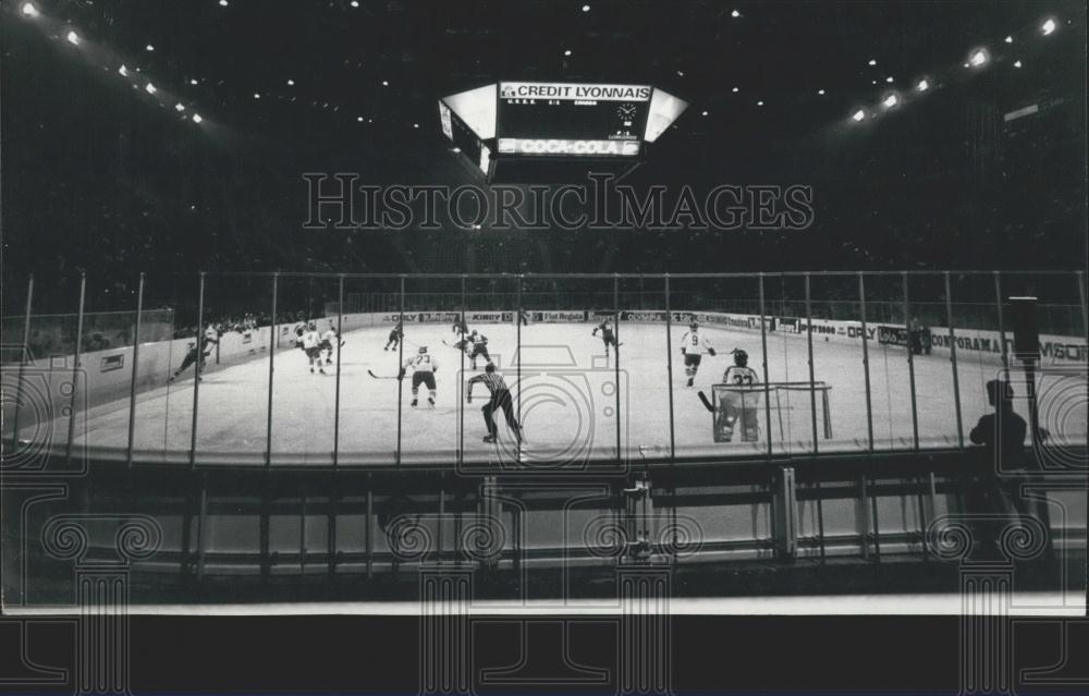 Press Photo Hockey Game As Person Looks On - Historic Images