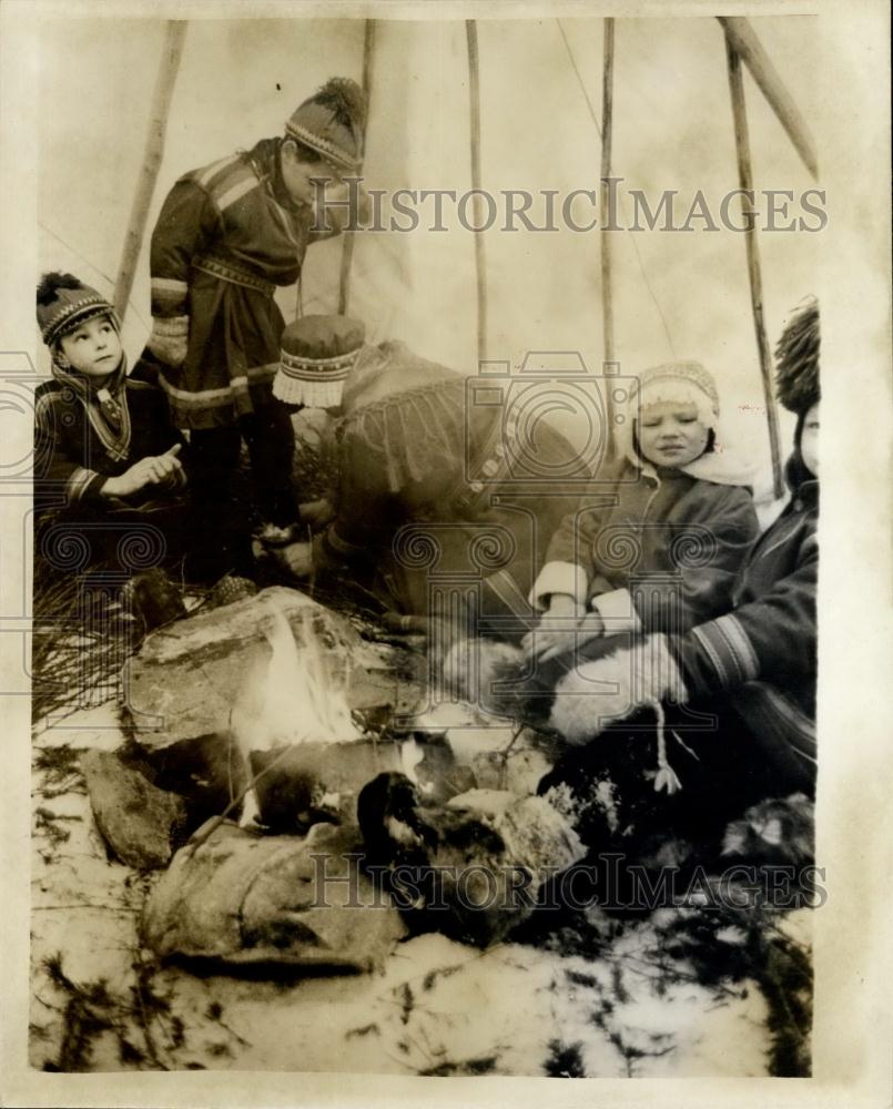 Press Photo Keeping Warm: In the family tent. Reindeer herders - Historic Images