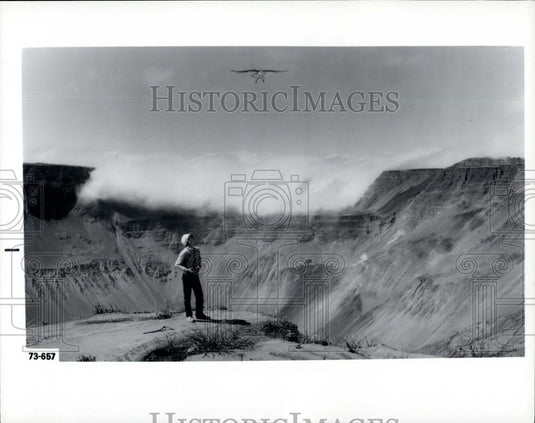 Press Photo research team watches a hawking over a volcanic caldera. - Historic Images