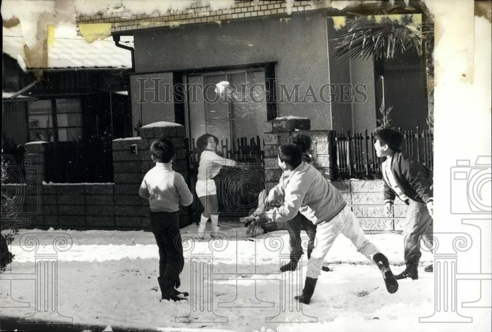 Press Photo Japanese children having snowball fight after drought - Historic Images