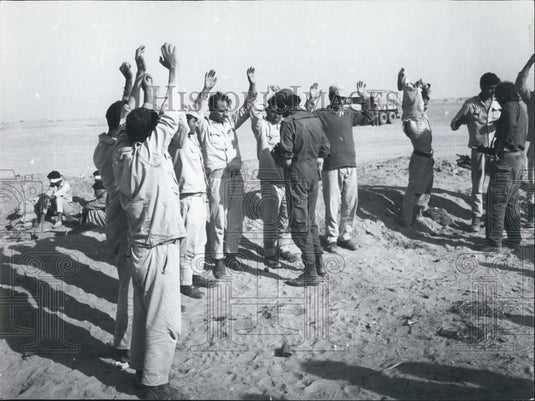 Press Photo Men Surrender To Captors With Men Blindfolded In Back Arabic - Historic Images