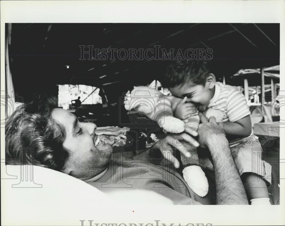 Press Photo Cuban Refugee Plays With Son - Historic Images