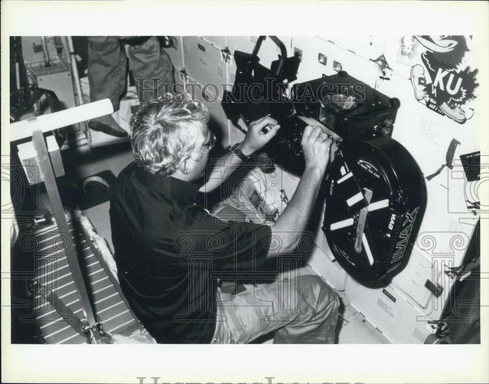 Press Photo A Man Operates IMAX Machinery - Historic Images