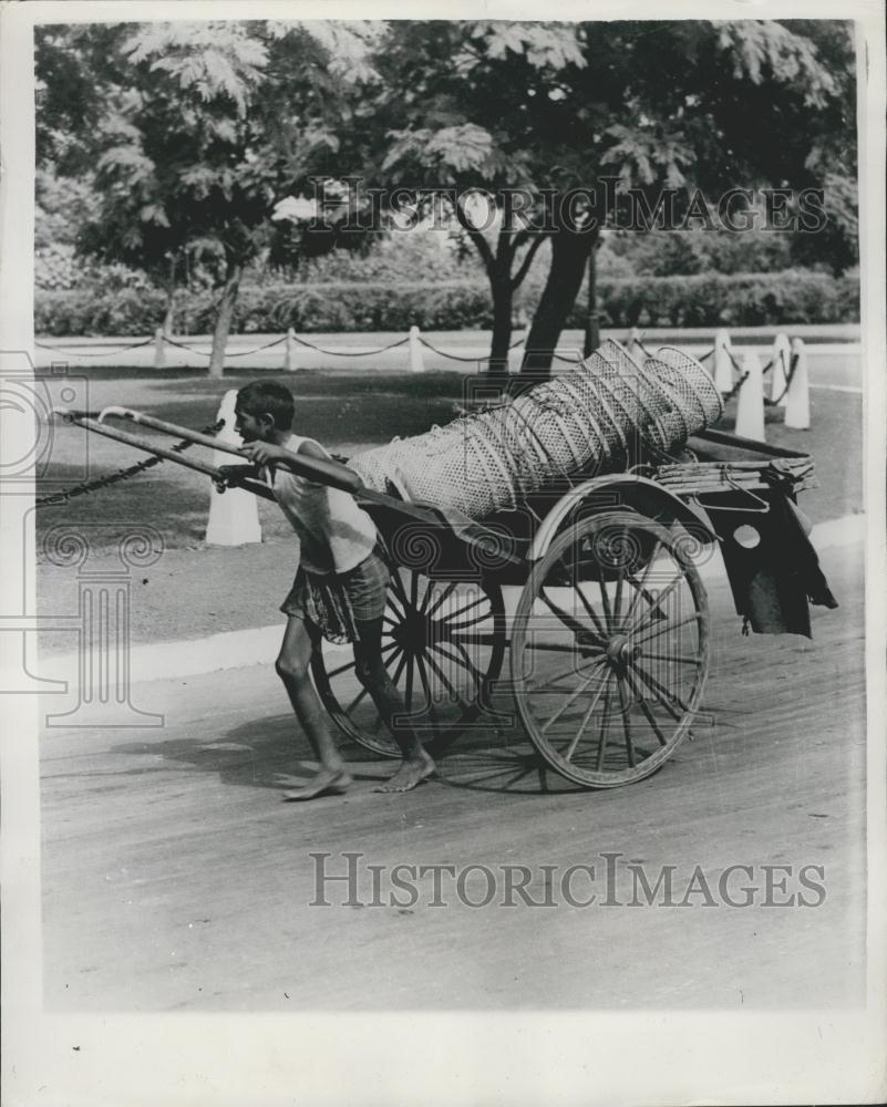 Press Photo Rickshaw Boy Carries Load in Calcutta - Historic Images