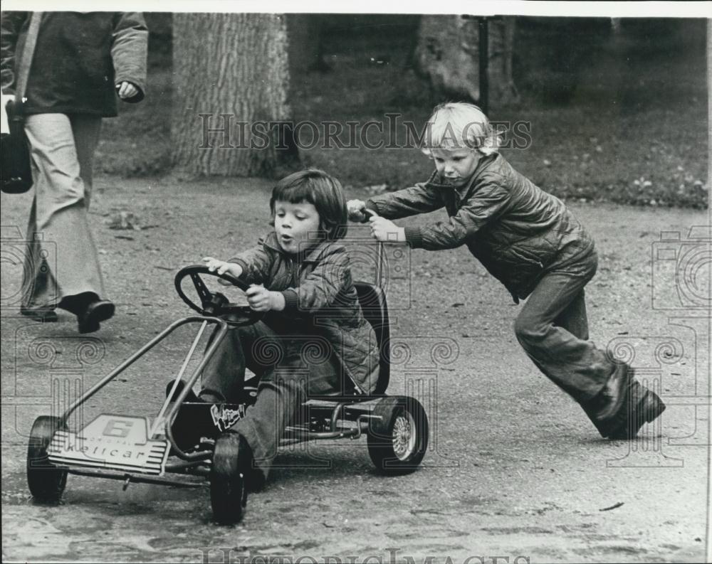 Press Photo Prince Frederick at the wheel as Prince Joachim gives him a push - Historic Images