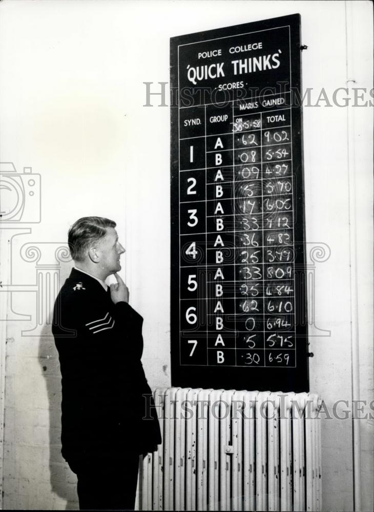 Press Photo sergeant puzzles over the &quot;Quick Thinks&quot; Board - Historic Images