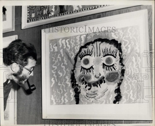 1953 Press Photo Cecil Riley an Art Teacher, looks at Baba Yaga"" - Historic Images