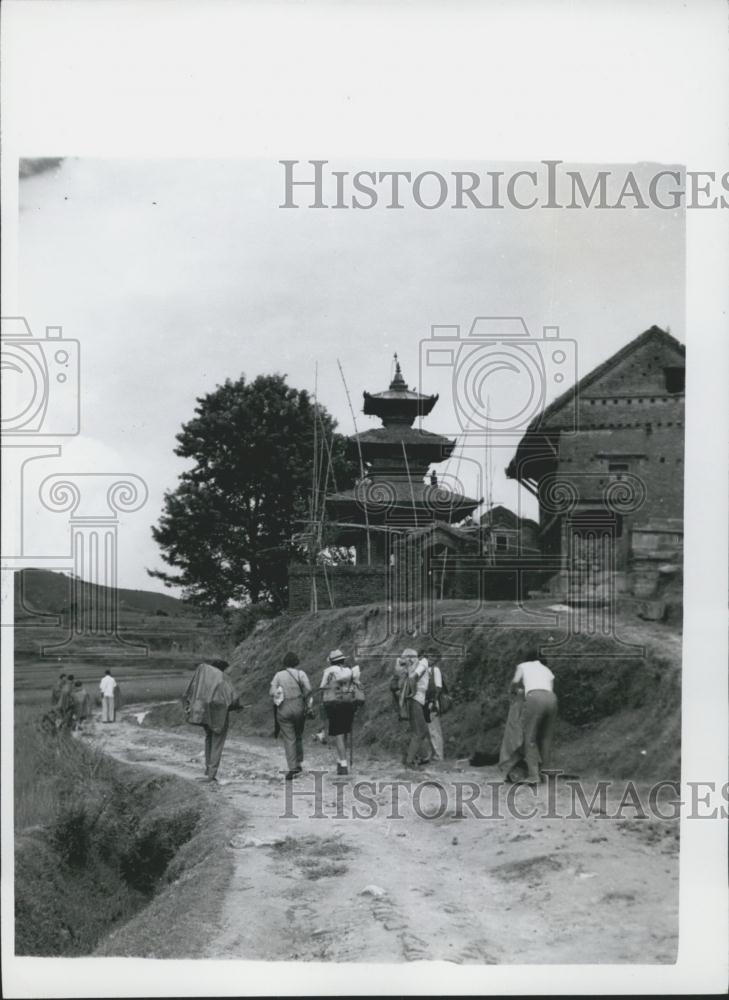 Press Photo Hikers in Nepal by a pagoda-like temple - Historic Images