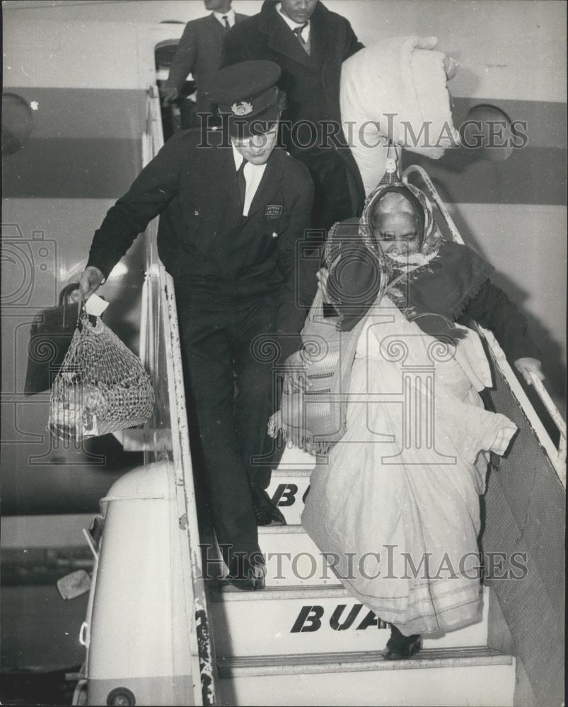 1968 Press Photo Elderly Asian Immigrant Helped Plane Arriving Getwick Airport - Historic Images