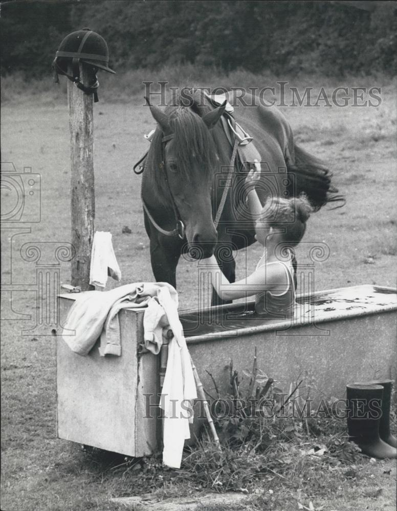 Press Photo Girl playing in her horses water trough - Historic Images