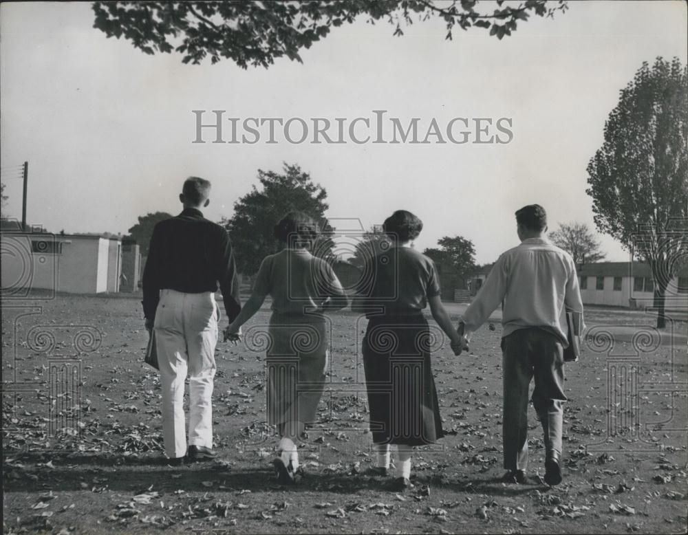 Press Photo Students Walk Through Autumn Leaves Across Campus Bushey School - Historic Images