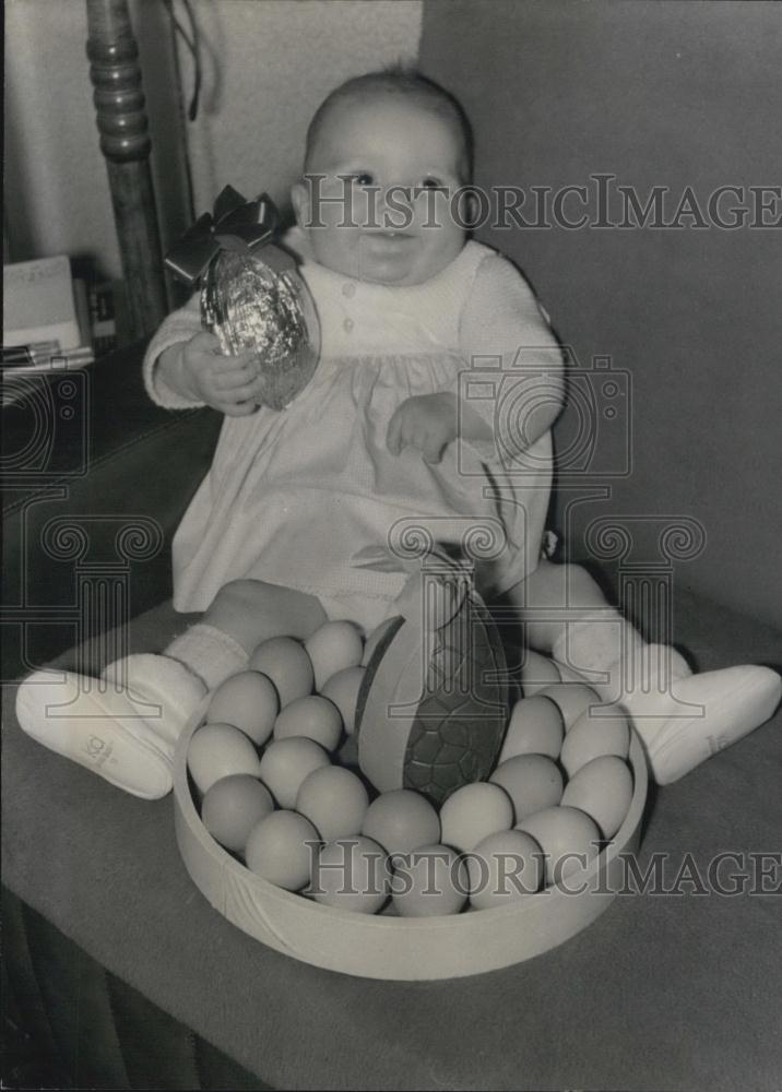 Press Photo Baby Seems quite happy with his collection of easter eggs - Historic Images