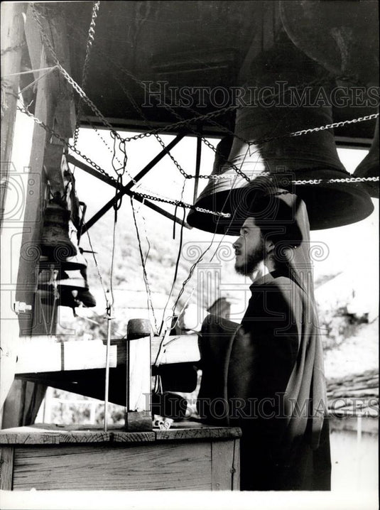 Press Photo An under-aged trainee-monk ringing the bell calling for prayers - Historic Images