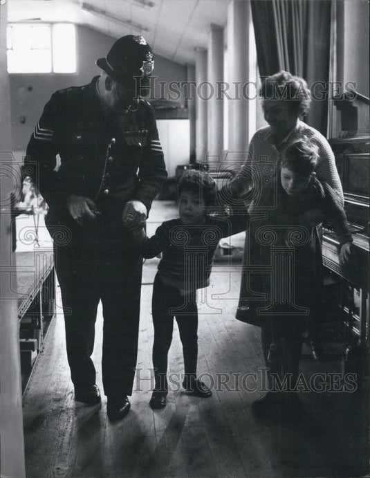 Press Photo Police Sergeant Walking With Nurse & Children In Nursery - Historic Images